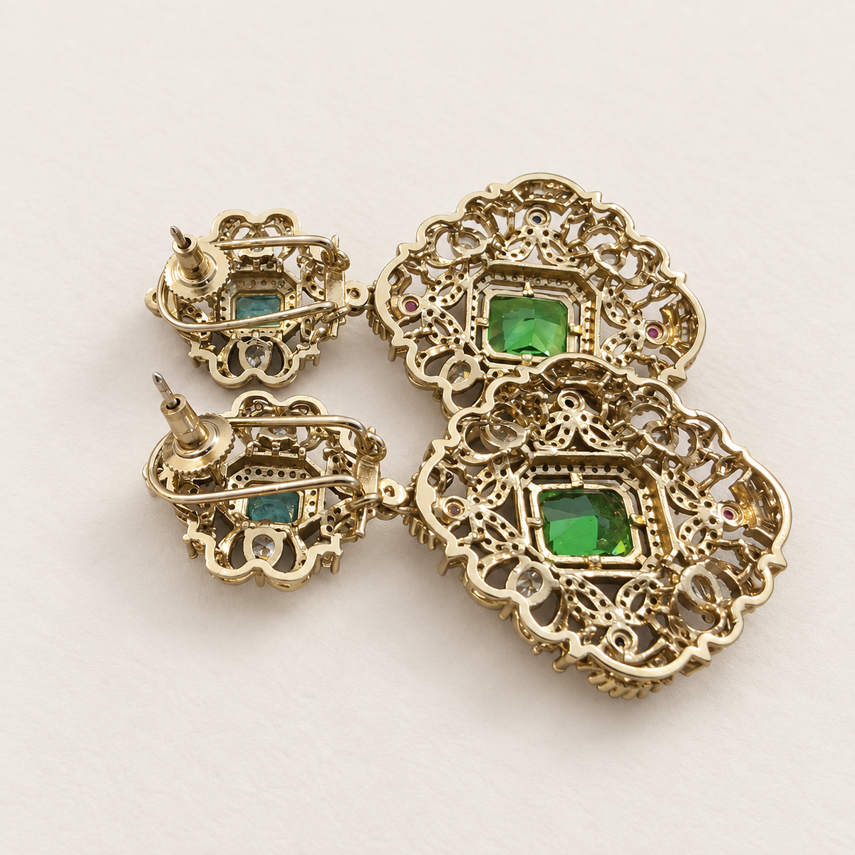 Post-back closure detail of emerald-green doublet statement earrings