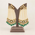 Front view of emerald and ivory pearl-strand kundan chandelier earrings